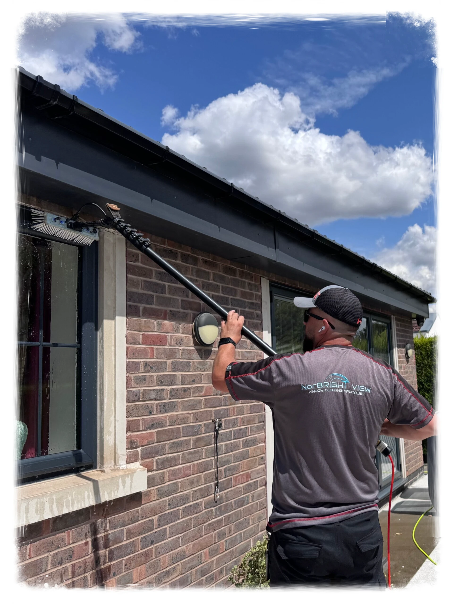 NorBRIGHT View window cleaner at work in a branded uniform