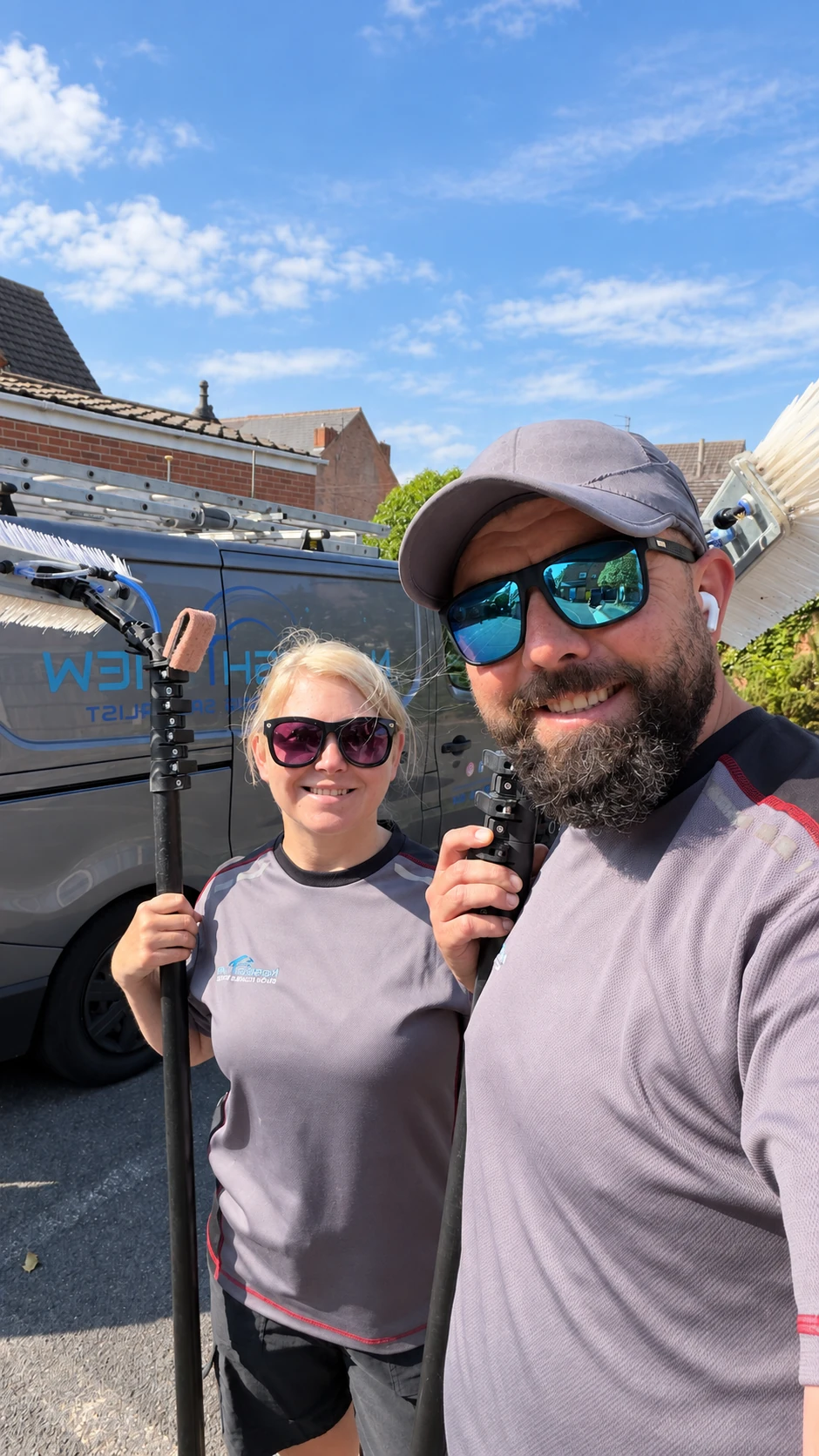 Norbi and his wife with their window cleaning brushes beside the NorBRIGHT View van