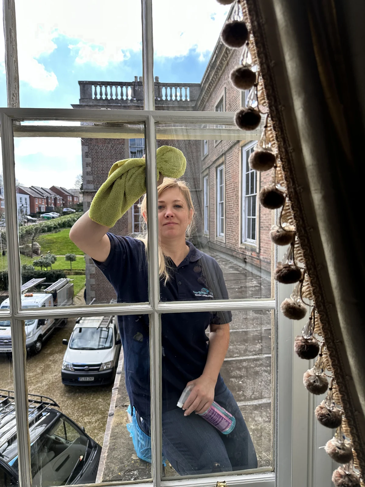 NorBRIGHT View team member carefully cleaning a sash window