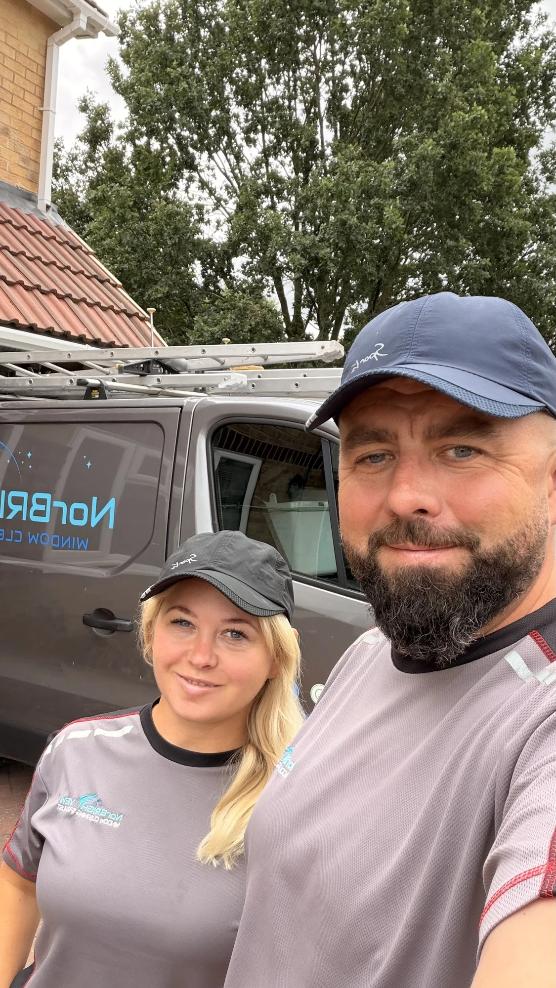 Norbi and his wife beside their NorBRIGHT View window cleaning van